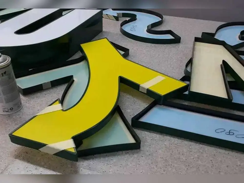 Aluminium channel letters in production, showing the built-up letter sides before assembly
